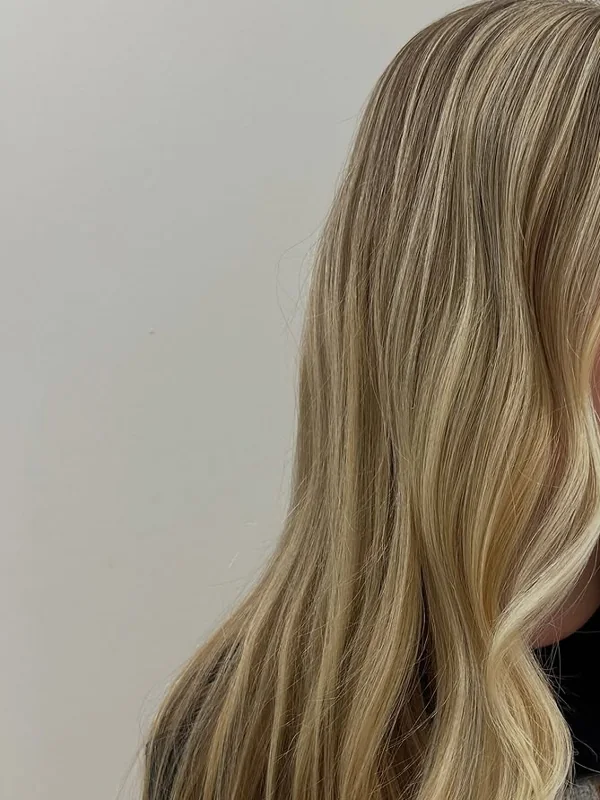Long blonde hair with bright woven highlights, colored by Amy Kurtz