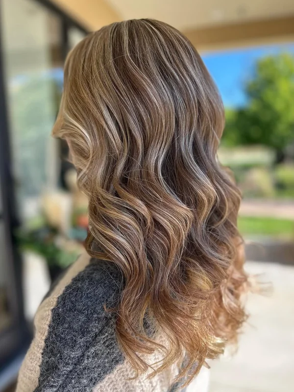 Long, dimensional blonde waves in natural light, highlighted by Amy Kurtz