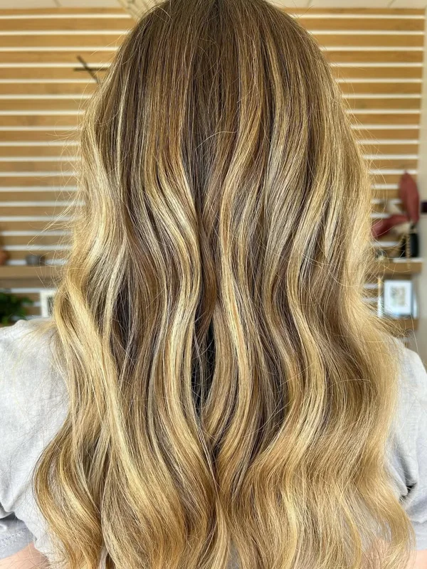 Long, sun-kissed blonde waves with bright face-framing pieces, by Amy Kurtz