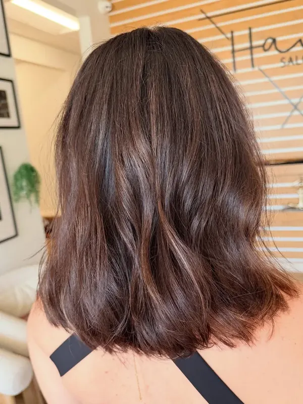 Rich glossy brunette color on a shoulder-length cut, by Amy Kurtz in her suite